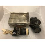 TWO WWII GAS MASKS AND A METAL CASE