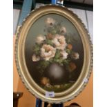 AN OVAL GILT FRAMED PICTURE OF A VASE OF PEONIES BY J COOPER