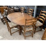 AN ERCOL EXTENDING ELM DINING TABLE WITH SIX ERCOL DINING CHAIRS
