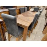 A MODERN LARGE PINE FARMHOUSE STYLE DINING TABLE AND EIGHT UPHOLSTERED CHAIRS