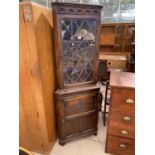 A REPRODUCTION GLAZED AND LEADED CORNER CABINET