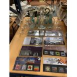 A QUANTITY OF GLASSWARE TO INCLUDE THREE DECANTERS AND A SELECTION OF MILLENIUM EDITION STAMPS