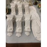 THREE PLASTER PLAQUES AND SIX PLASTER WALL STANDS