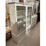 A WHITE PAINTED GLAZED AND LEADED TWO DOOR CABINET WITH CUPBOARD TO BASE