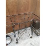 A VINTAGE WROUGHT IRON TABLE BASE ON CASTERS