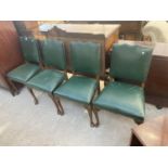 A SET OF FOUR GEORGIAN STYLE DINING CHAIRS, UPHOLSTERED IN GREEN LEATHER AND STUDDED RIMS, ON