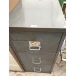 A THREE DRAWER METAL FILING CABINET