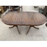 A MAHOGANY EXTENDING DINING TABLE ON TWIN PEDESTAL SUPPORTS