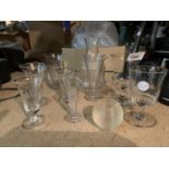 A GROUP OF GLASSWARE TO INCLUDE FIVE MEASURES, A MATCH STRIKER, DECANTER AND TWO GLASSES