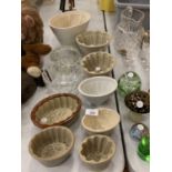 A SELECTION OF GLASS AND POTTERY JELLY MOULDS