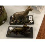 TWO BRASS DOG ORNAMENTS MOUNTED ON MARBLE PLINTHS