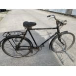 A VINTAGE BICYCLE WITH FRONT LIGHT AND REAR RACK