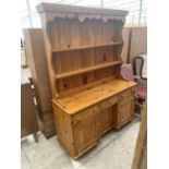 A MODERN PINE DRESSER COMPLETE WITH PLATE RACK, 52" WIDE