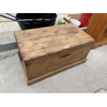 A VINTAGE PINE TRUNK WITH CAST IRON HANDLES