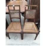 A PAIR OF EARLY 20TH CENTURY MAHOGANY BEDROOM CHAIRS WITH SPLIT CANE SEATS AND BACKS