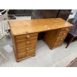 A PINE DESK WITH EIGHT DRAWERS