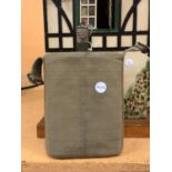 A CANVAS COVERED ARMY WATER BOTTLE WITH CORK STOPPER