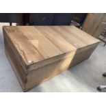 A LARGE PINE LIDDED STORAGE BOX, 50x24"