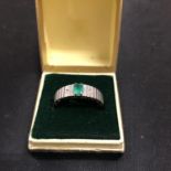 AN EMERALD AND DIAMOND THREE STONE RING, STAMPED 750, N.5 SIZE