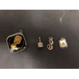 THREE SILVER CHARMS AND A GUERNSEY TEN SHILLING COIN PENDANT