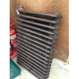 A VINTAGE CAST IRON RADIATOR, HEIGHT 56CM, WIDTH 88CM, DEPTH 15CM