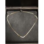 AN 18CT GOLD NECKLACE SET WITH THREE IN LINE SAPPHIRES ALTERNATED WITH FOUR DIAMONDS PURCHASED