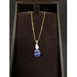 A BEAVERBROOKS BLUE AND CLEAR STONE PENDANT ON A 9CT GOLD NECKLACE