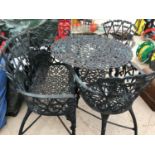 A VERY HEAVY CAST IRON GARDEN TABLE INCLUDING TWO CHAIRS AND A TWO SEATER BENCH