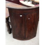 A GEORGE III MAHOGANY AND INLAID BOWFRONTED CORNER CUPBOARD, 31" WIDE