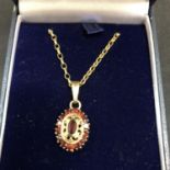 A GARNET PENDANT ON A 9CT GOLD NECKLACE 3.6 GRAMS