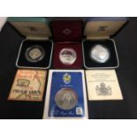 FOUR COMMEMORATIVE COINS IN PRESENTATION WALLETS AND BOXES
