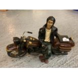 A RESIN MOTORCYCLE WITH LEANING FIGURE
