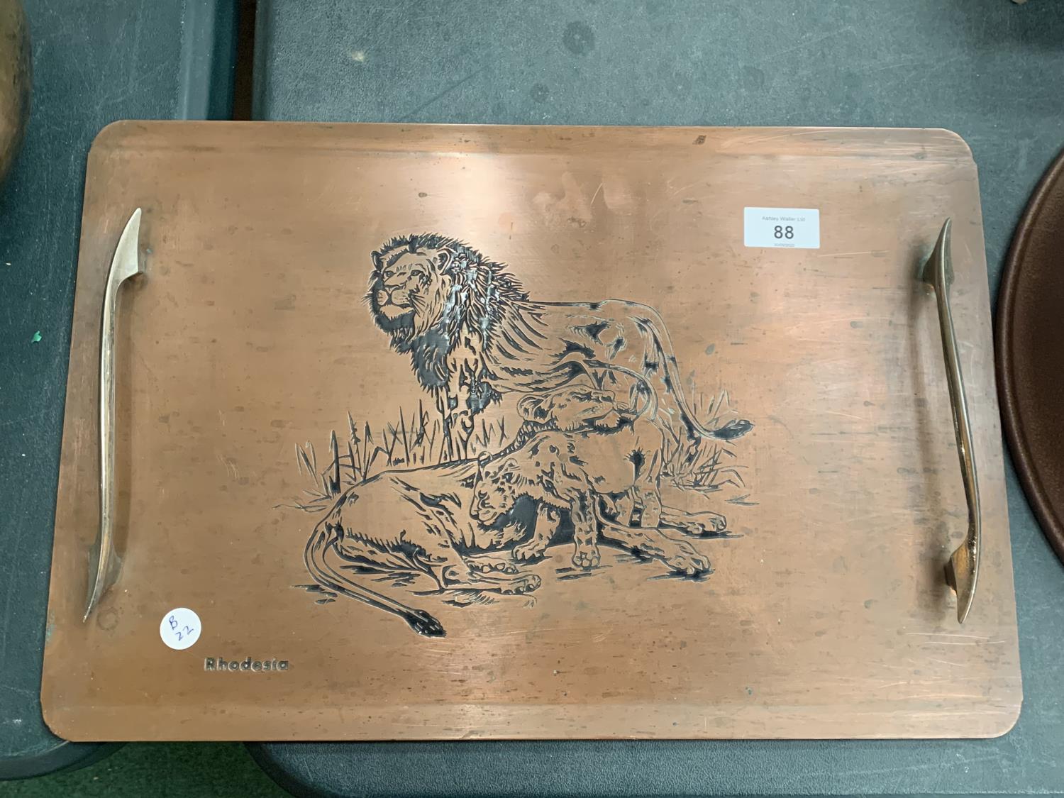 A RHODESIAN COPPER TRAY WITH HANDLES DEPICTING A FAMILY OF LIONS