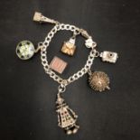 A SILVER CHARM BRACELET WITH SEVEN CHARMS