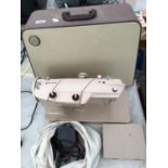 A CASED SINGER SEWING MACHINE BELIEVED WORKING BUT NO WARRANTY