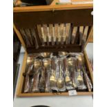 A NEW WOODEN BOXED CANTEEN OF CUTLERY BRONZE WITH WOODEN HANDLES