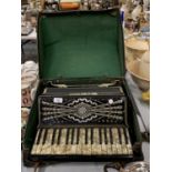 A DELFINI ACCORDIAN WITH MOTHER OF PEARL STYLE KEYS AND INLAID DETAIL TO INCLUDE CARRY CASE
