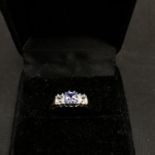 A 9CT GOLD RING SET WITH AN AQUAMARINE AND TWO CUBIC ZIRCONA 2.3 GRAMS