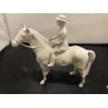 A BESWICK WHITE FIGURINE OF A HUNTSWOMAN ON A HORSE