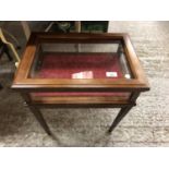 A MAHOGANY FOUR LEGGED DISPLAY CABINET