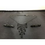 A BLACK NECKLACE AND TWO BROOCHES ONE WHITBY JET