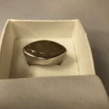 A BOXED WHITE METAL RING WITH STONE