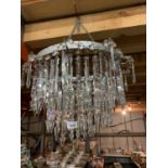 AN EDWARDIAN CUT GLASS CHANDELIER WITH THREE RINGS
