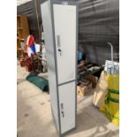 A TALL TWO DOOR METAL LOCKER WITH KEYS