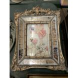 A HEAVY WOODEN GILT AND MIRRORED FRAME WITH SCROLL DESIGN