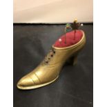 A BRASS SHOE PIN CUSHION