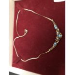 A 9CT GOLD NECKLACE SET WITH THREE AQUAMARINES AND FOUR DIAMOND CHIPS GROSS WEIGHT 6.6 GRAMS