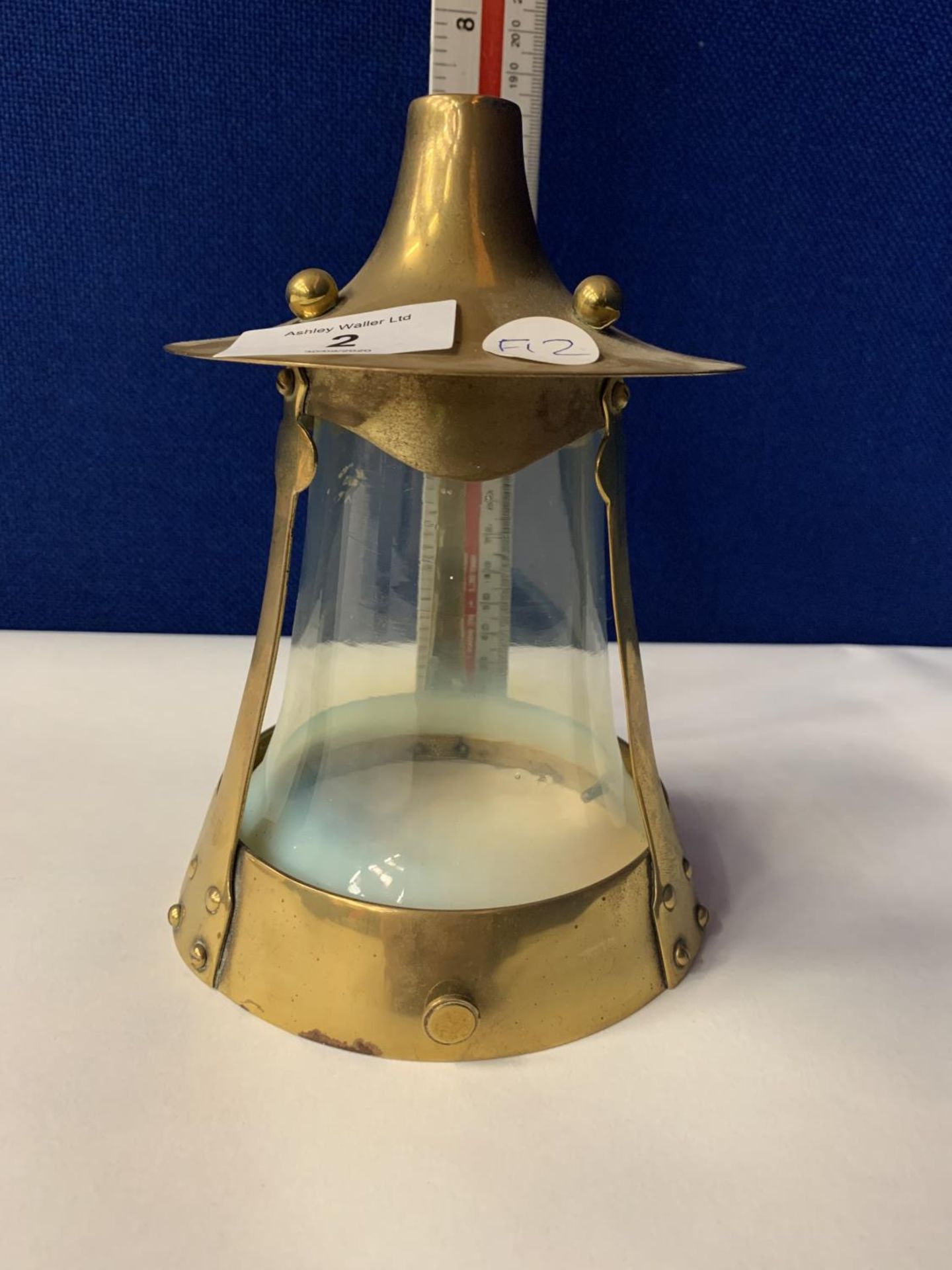AN ART NOUVEAU BRASS LAMP WITH VASELINE OPALESCENT GLASS SHADE