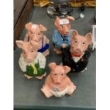 A SET OF 'THE NAT WEST PIG FAMILY' MONEY BOXES COMPLETE WITH STOPPERS