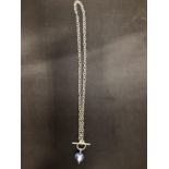 A SILVER T-BAR NECKLACE WITH A BLUE STONE